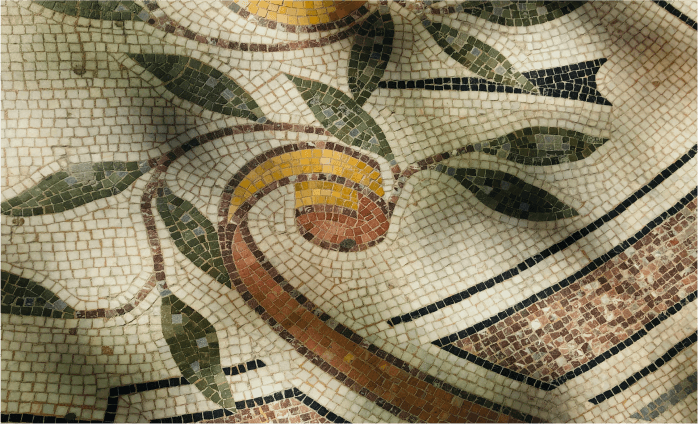 Mosaic tile floor depicting ribbons and leaves.